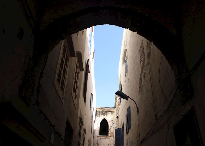 An archway gives way to the blue sky of Essaouira
