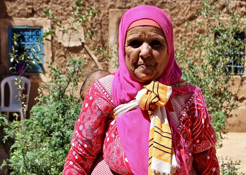 A Berber woman wears a traditional pink jeleba and headscarf