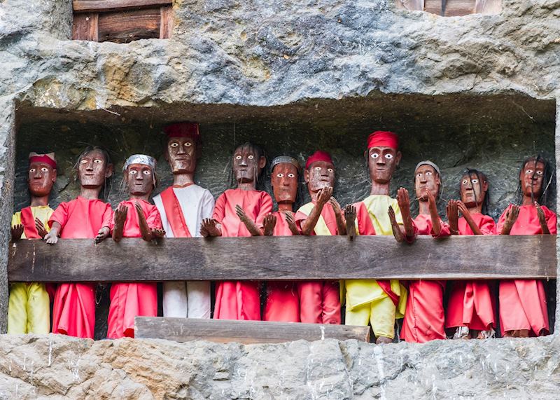 Wooden figures placed in the limestone cliffs, Suaya