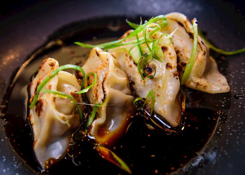 Pork gyoza served with a dipping sauce