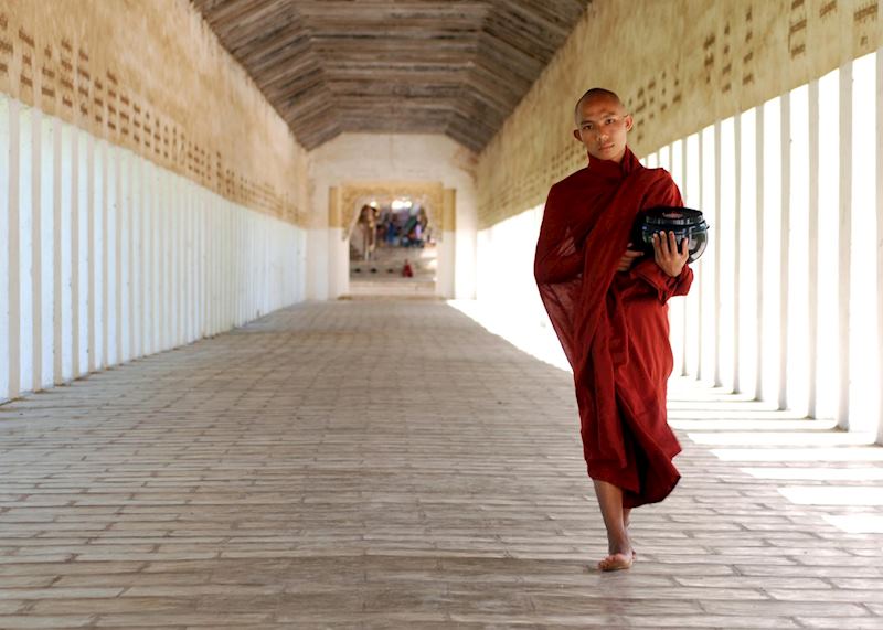 A novice monk returns from the Shwezigan Pagoda with alms in Bagan