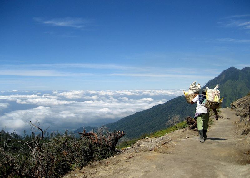 Familiar sight of a sulphur miner whilst descending from the summit of Gunung Ijen