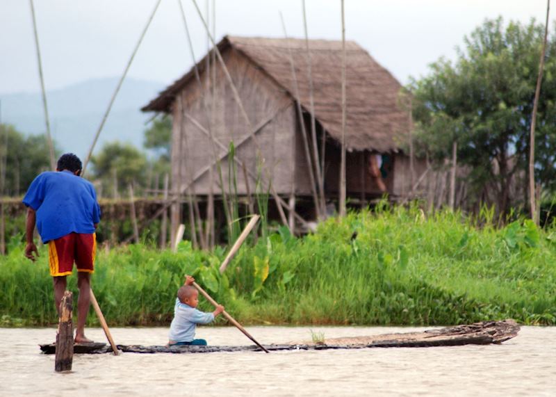 Father and son paddle on their home-made boat, Inle Lake
