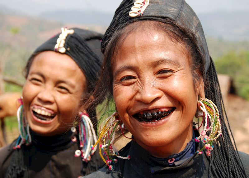Women of the Ann tribe paint their teeth black