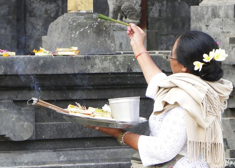Balinese woman presenting an offering during a temple ceremony