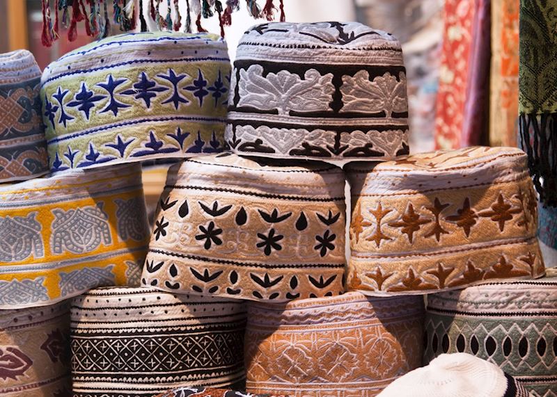 Men's caps in souq, Muscat