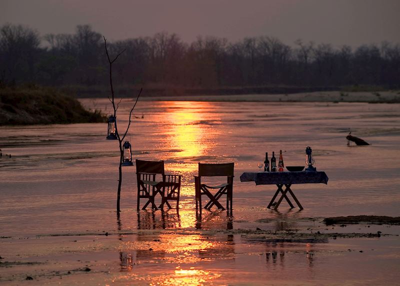 Sundowner drinks in the Kapamba River by the Bushcamp Company